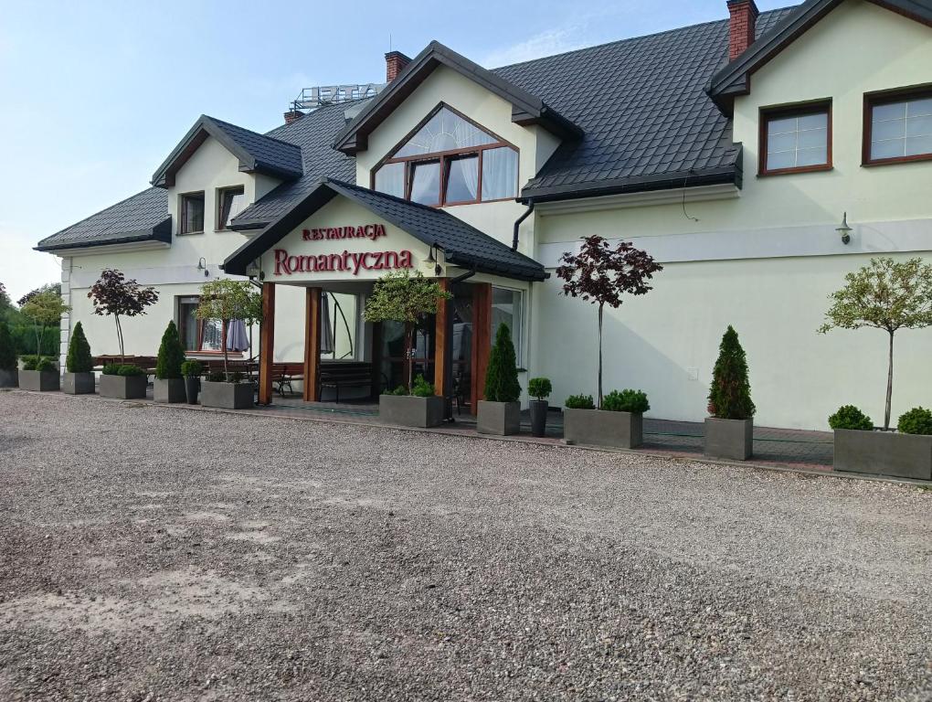 a building with a sign on the front of it at Hotel Romantyczny in Międzyrzec Podlaski