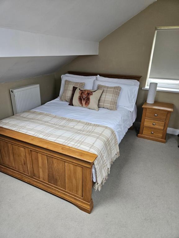 a bedroom with a bed with a dog pillow on it at The Attic in Dove Holes