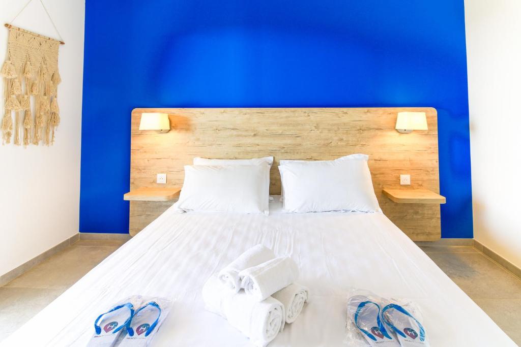 a bedroom with a bed with flip flops on it at SELECT' - T2 à Saint-Clair au Lavandou dans une résidence neuve avec piscine - 180SUD-B12 in Le Lavandou
