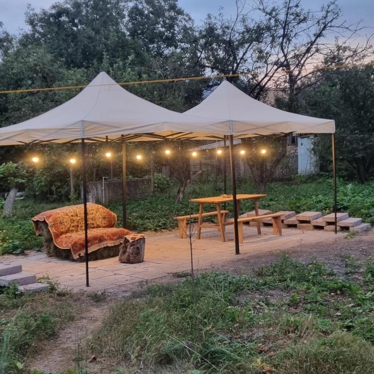 a tent with a couch and a table under it at Hooni_guesthouse in Odzun