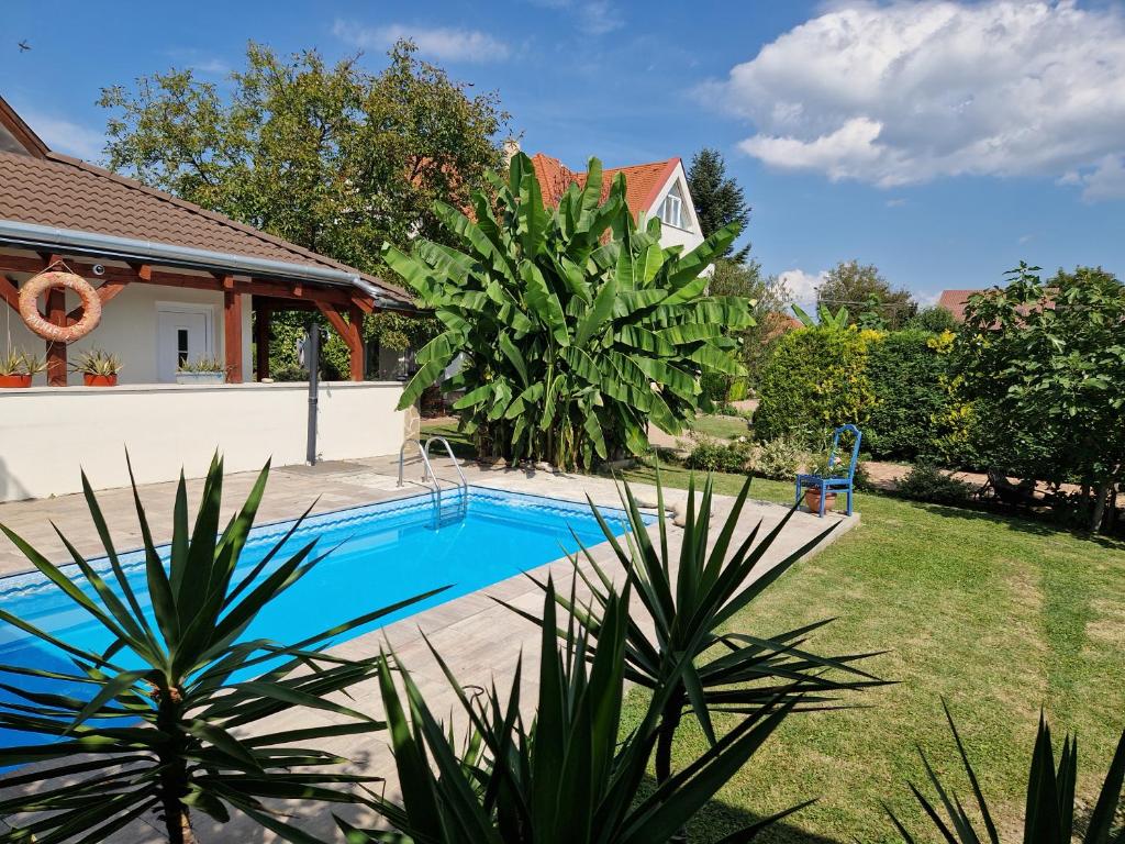 a swimming pool in the yard of a house at Andrea Villa Keszthely in Keszthely