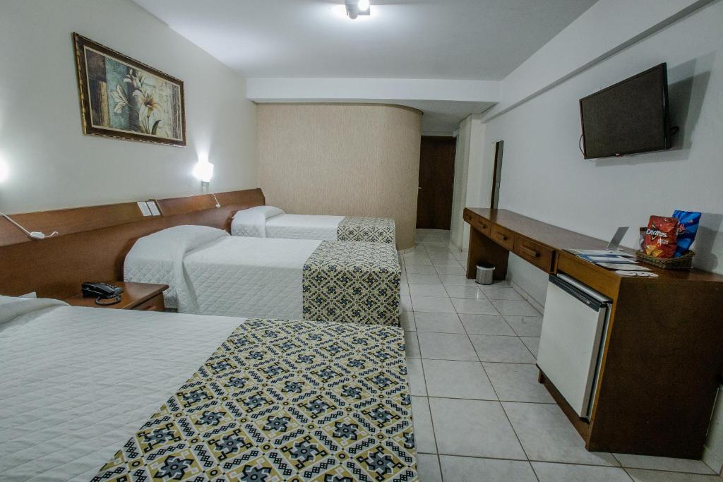 Postel nebo postele na pokoji v ubytování Foz Presidente Comfort Hotel