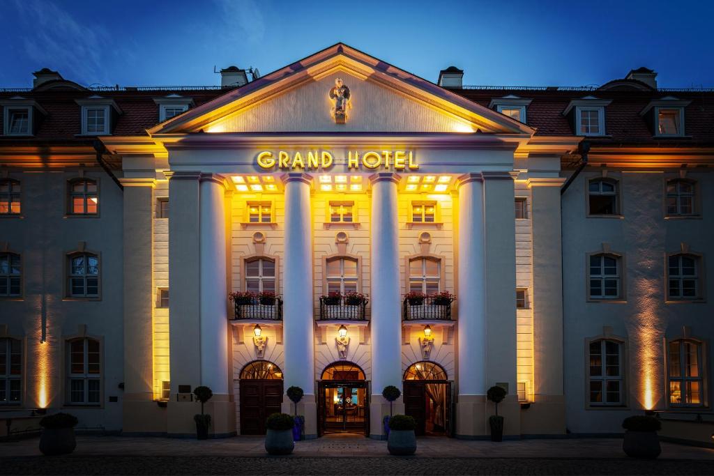 a grand hotel is lit up at night at Sofitel Grand Sopot in Sopot