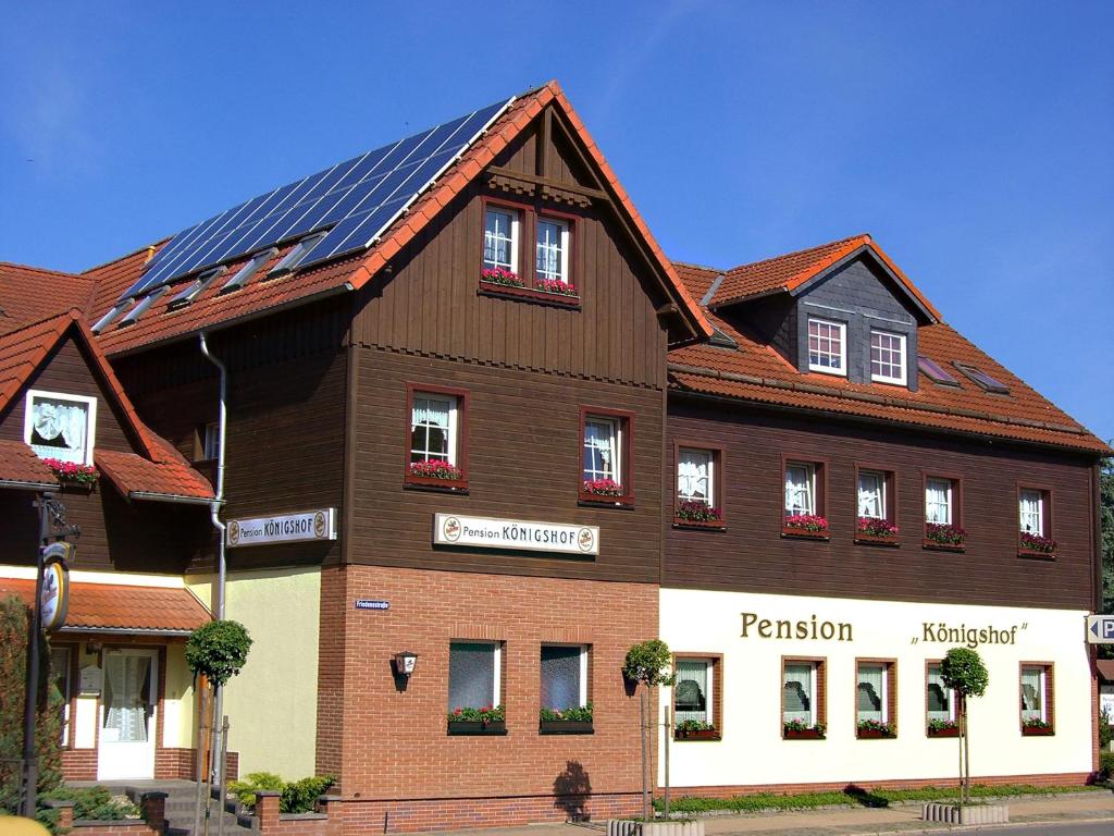 a large brown building with solar panels on it at Pension Königshof 