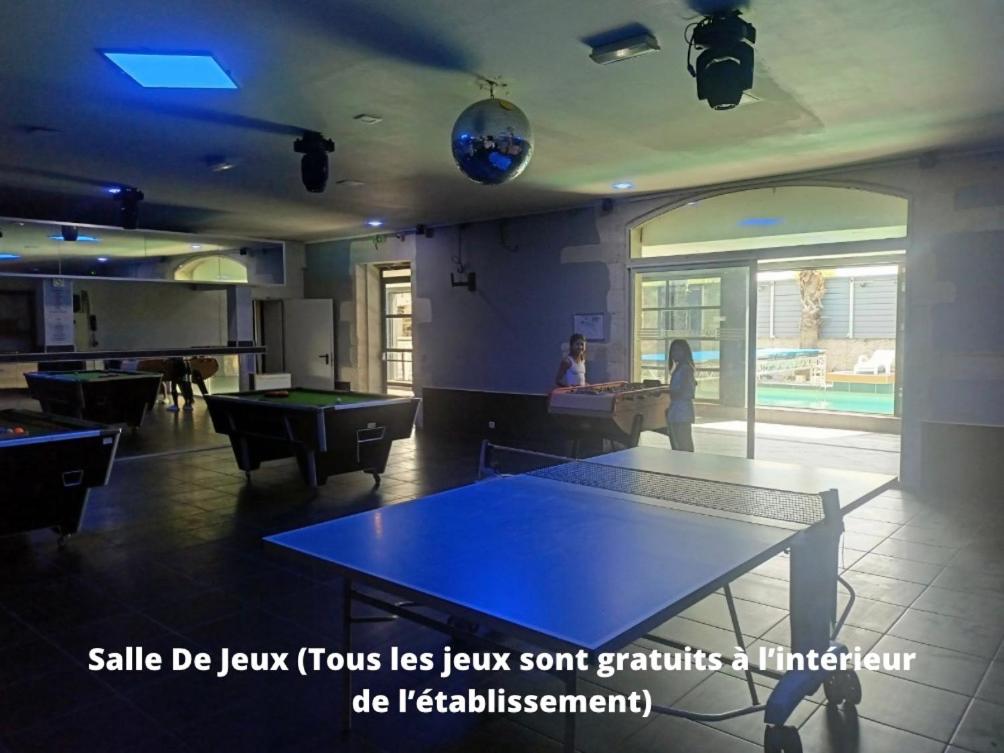 a room with a ping pong table and a woman at Mas La Farelle Chambre d&#39;hote,Fitness &amp; Salle de jeux Gratuite &amp; SPA en supplément in Nîmes