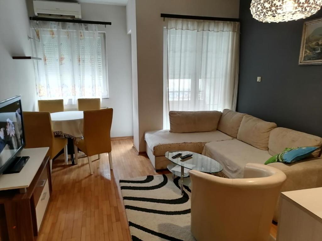 a living room with a couch and a table at Dream S in Niš