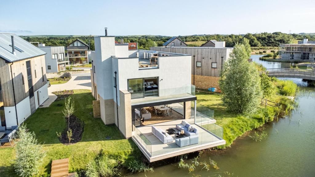an aerial view of a house with a river at Serenity WI27 - Silverlake - Dorset in Warmwell