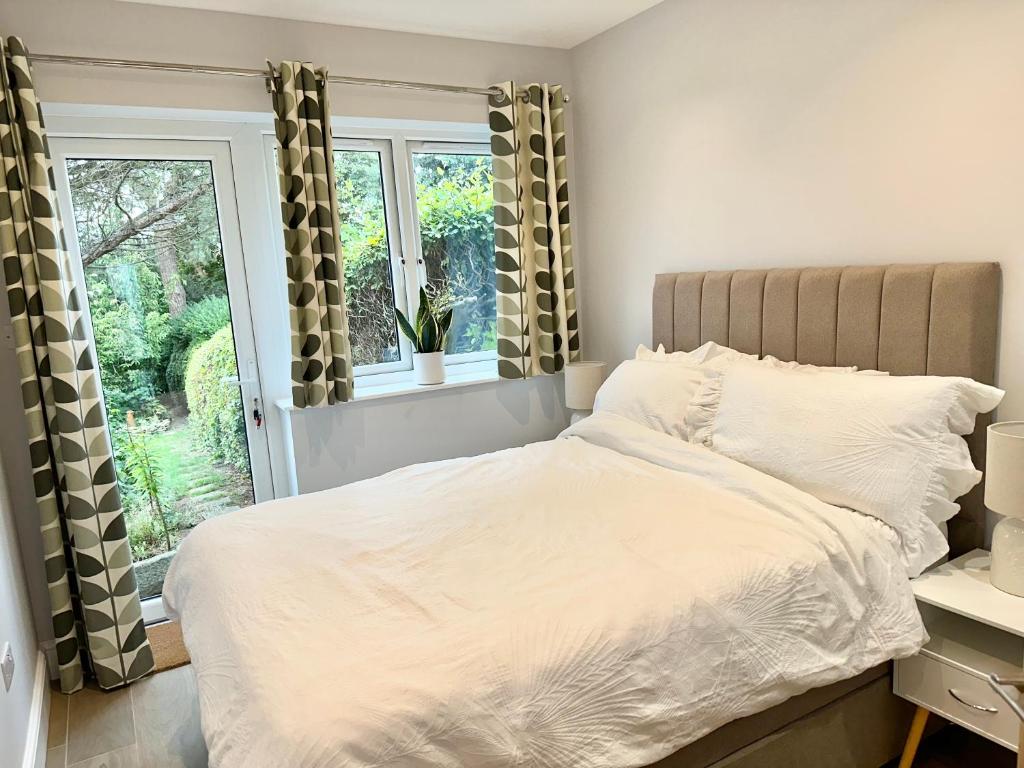 a bedroom with a bed and a window at Little Vine - Beautiful Ground floor flat in South London in Sutton