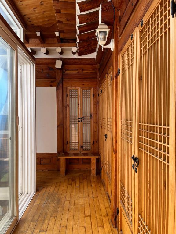 an empty room with wooden walls and a wooden floor at SeoulStory Hanok in Seoul