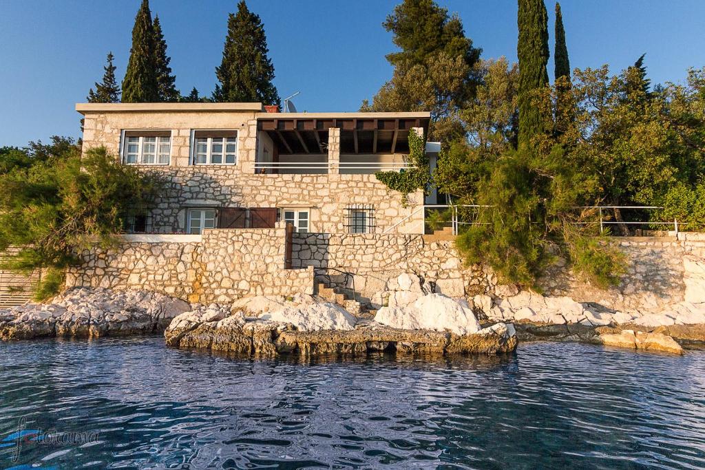 a house on a rocky island in the water at Holiday Home Marija in Dramalj