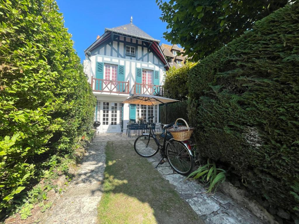 una bicicleta estacionada frente a una casa en Villa normande - Les Crapauds Fous, en Deauville