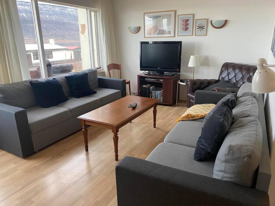 a living room with a couch and a tv at House in the Westfjords in Súðavík