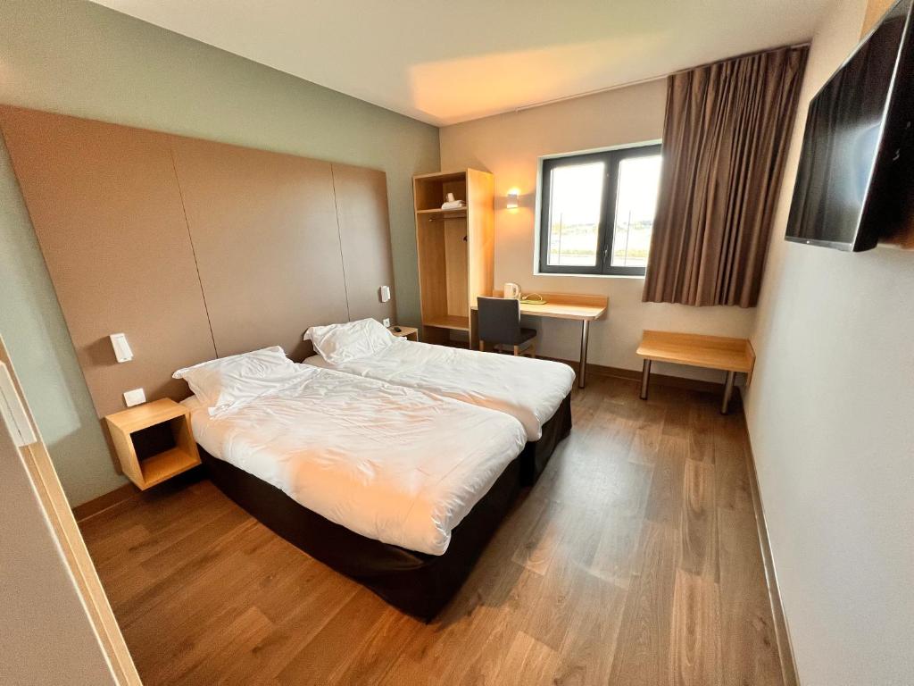 Postel nebo postele na pokoji v ubytování Campanile Metz Nord - Woippy- Porte du Luxembourg A31