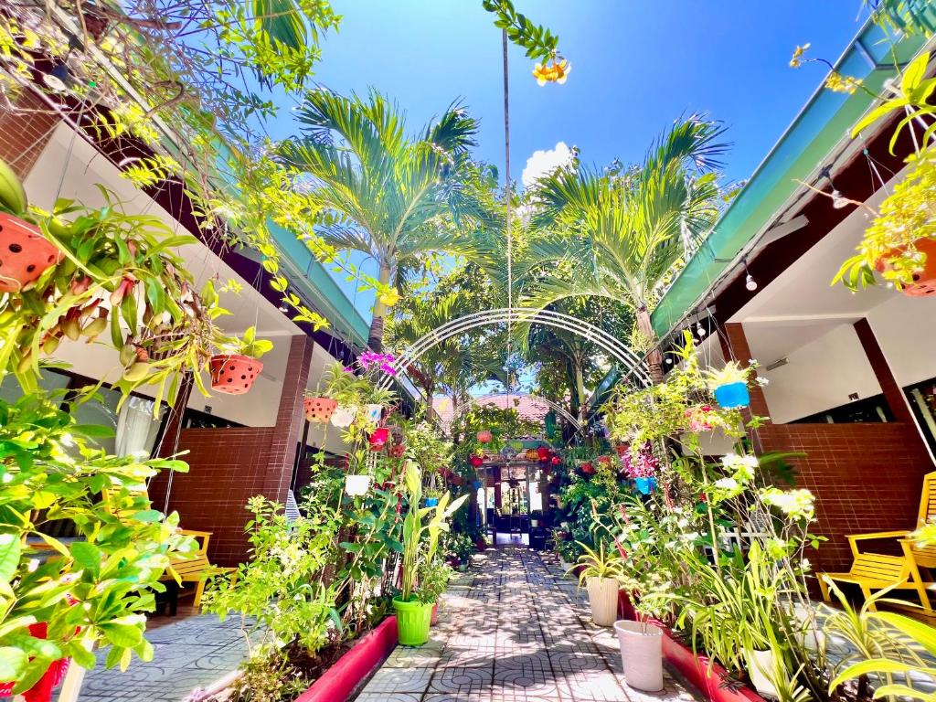 a garden corridor in a building with plants at Canary Bungalow in Phu Quoc
