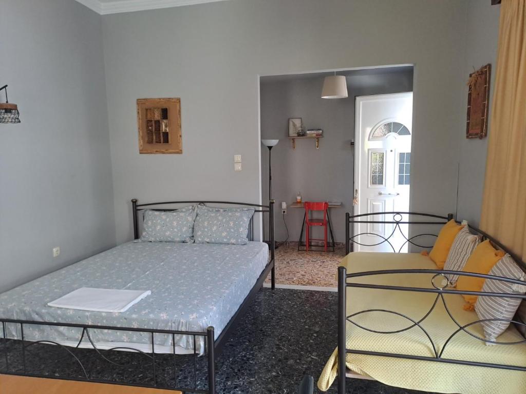 a bedroom with a bed and a chair at Dimitris place near Athens airport in Koropi