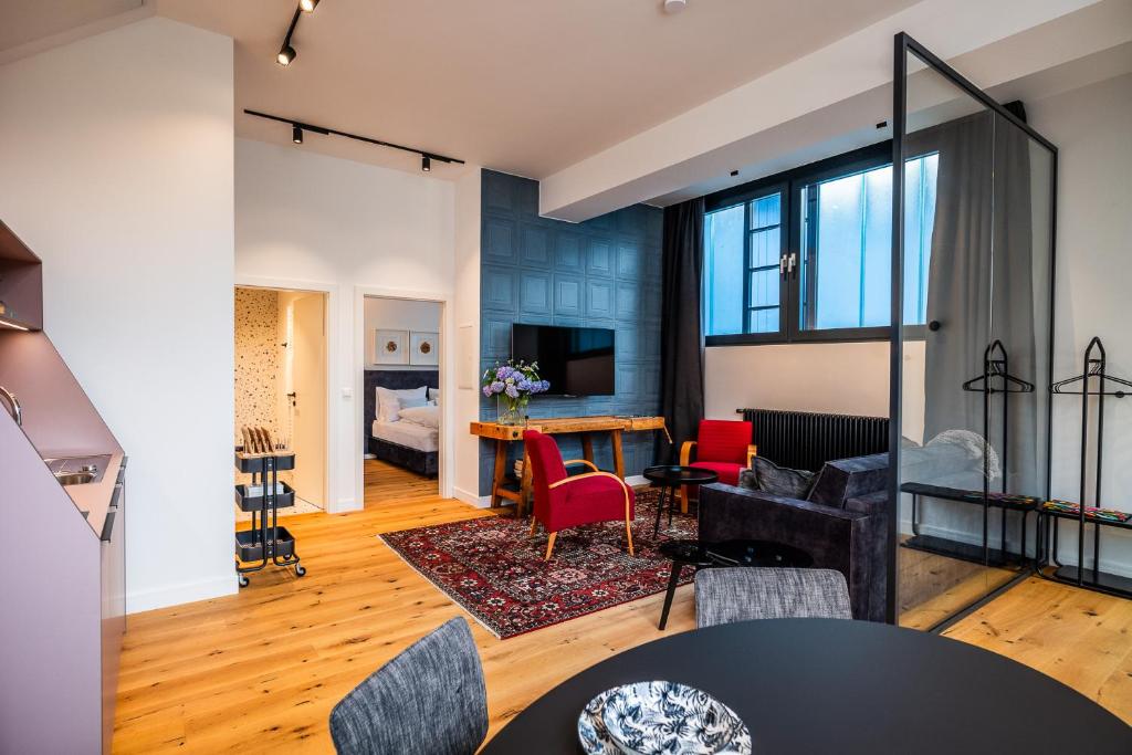 a living room with a table and chairs at Apartments Leopold Ferdinand in Sankt Stefan im Lavanttal