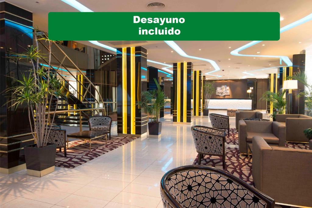 a lobby with chairs and a sign that reads dysko india at Holiday Inn Rosario, an IHG Hotel in Rosario