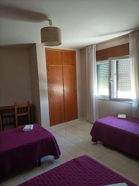 Postel nebo postele na pokoji v ubytování HOSTAL ALTO PÁRAMO