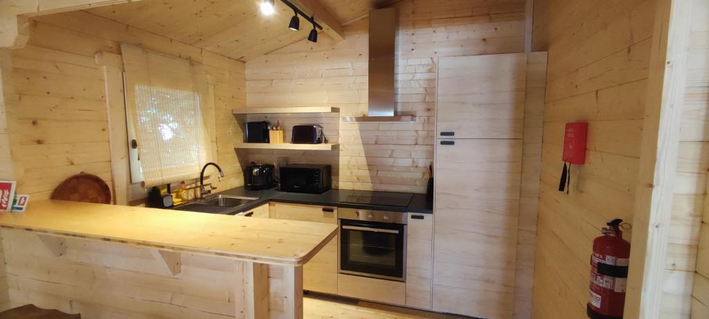 a kitchen with wooden walls and a counter in a room at Casa do Bosque in Sintra