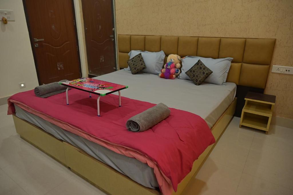 a bedroom with a large bed with a table on it at Matree Grand Lodge in Guwahati