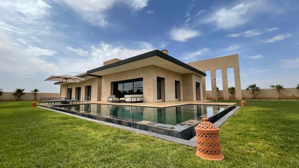 a house with a swimming pool in front of it at Villa Nisrine Your Private Oasis With Pool and No Overlooking in Marrakech