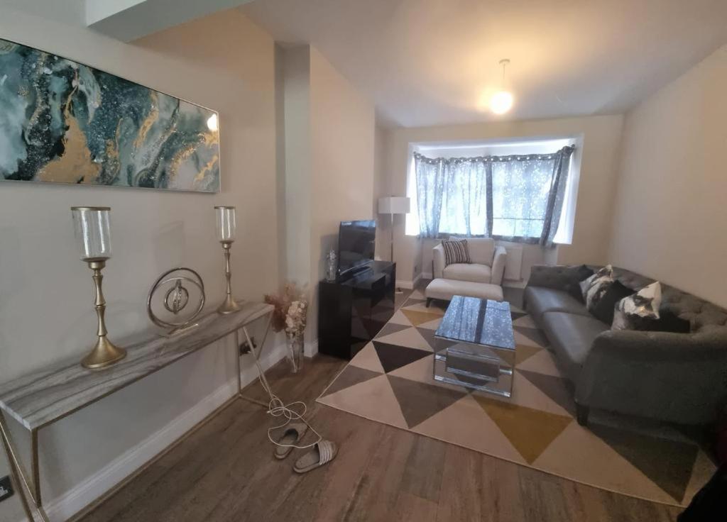 a living room with a couch and a table at Westcliff - On -Sea in Southend-on-Sea