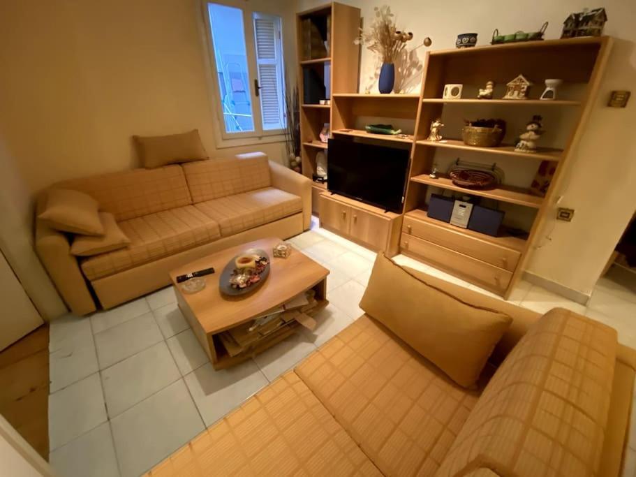 a living room with a couch and a coffee table at Cute 2bdrm in Salonica Center in Thessaloniki