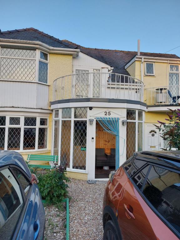 a house with a balcony on top of it at Sea Air B&B in Chapel Saint Leonards