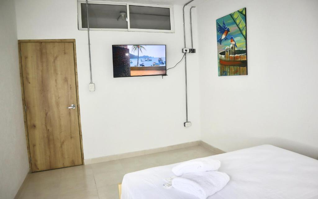 Postel nebo postele na pokoji v ubytování Hostal Las Guaduas