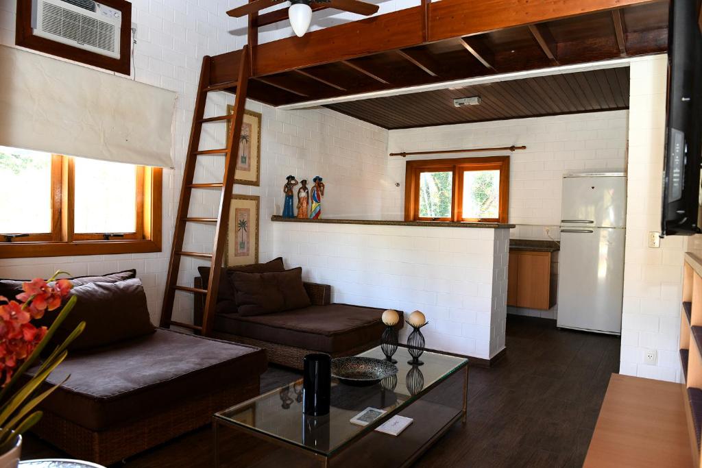 a living room with a couch and a loft bed at Sitio Agua Doce in Santa Branca