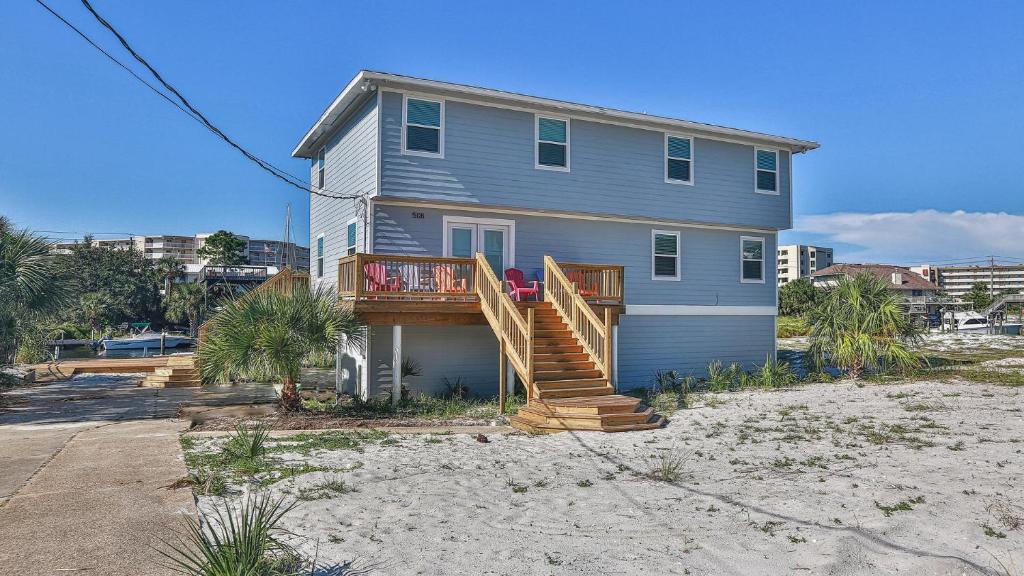 a house with a deck on the beach at The Back Porch - Is a relaxing 4 bedroom 3 bathroom House on Holiday Isle in Destin