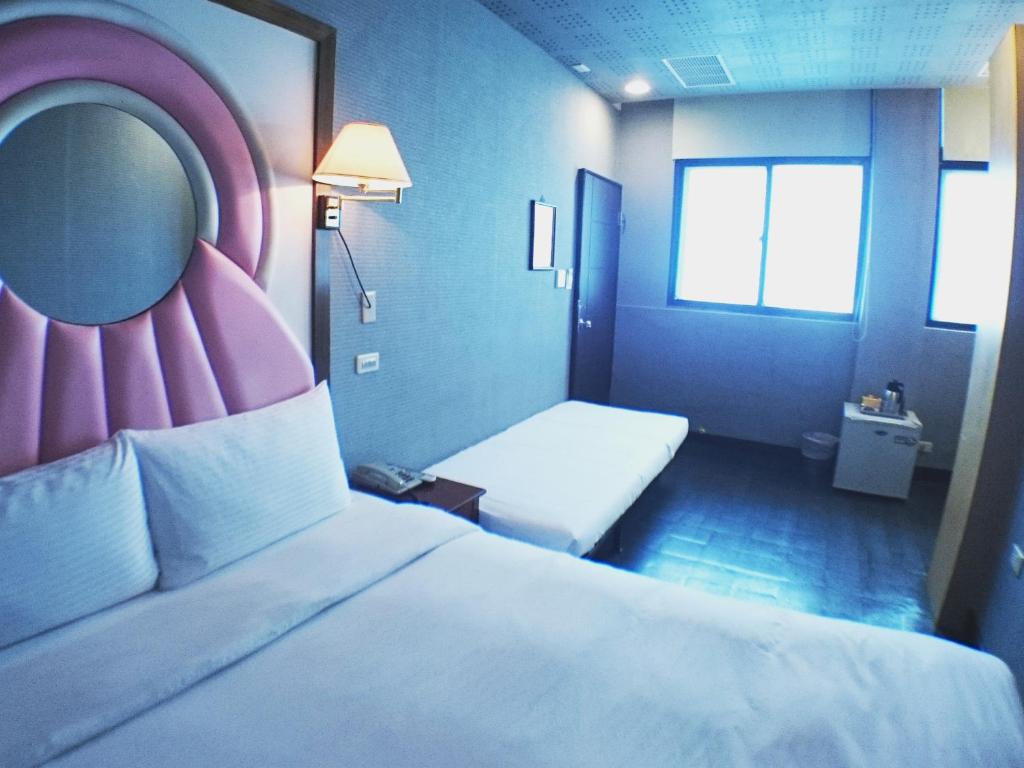 Postel nebo postele na pokoji v ubytování Fu Chia Hotel