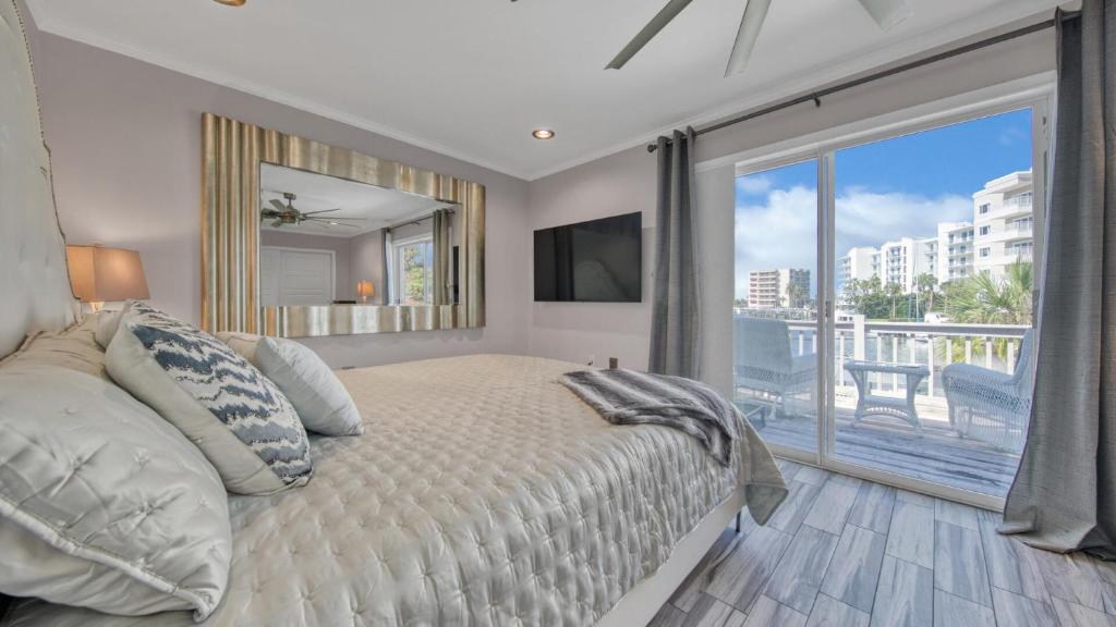 a bedroom with a bed and a large window at Red Hot Retreat - Updated Holiday Isle Townhome on the Destin Harbor in Destin
