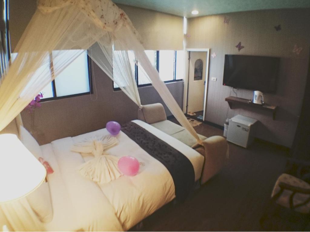Postel nebo postele na pokoji v ubytování Fu Chia Hotel