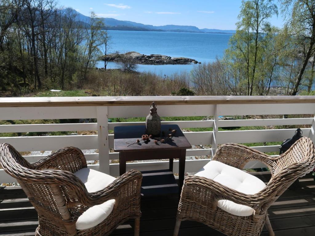 two chairs and a table on a porch with a view of the water at Holiday Home Villa Hjartnes by Interhome in Hjartåker