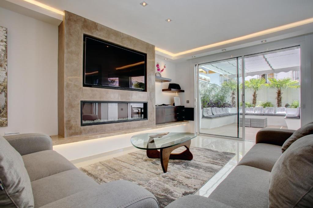 a living room with a couch and a tv at Casa Stefania in Marbella