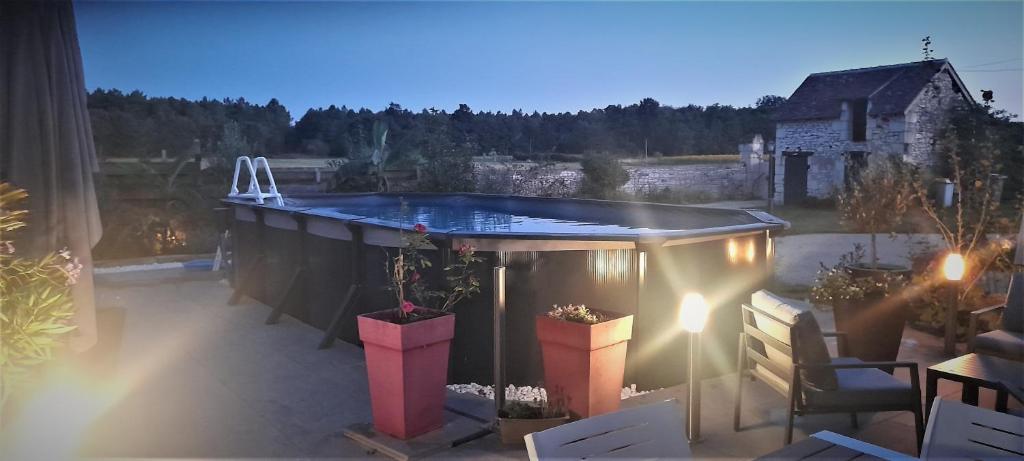 a hot tub sitting on top of a patio at STUDIO EN TOURAINE in Rilly-sur-Vienne