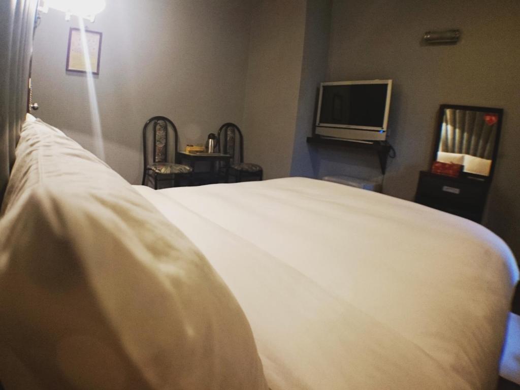 Postel nebo postele na pokoji v ubytování Fu Chia Hotel