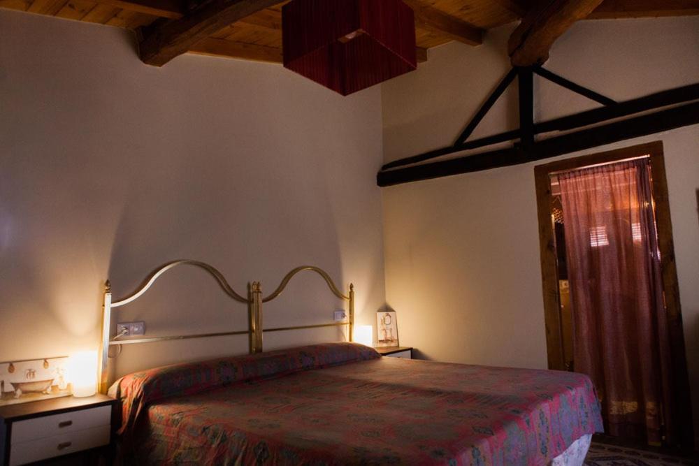 a bedroom with a large bed in a room at casa rural La Morucha de Hervás in Hervás