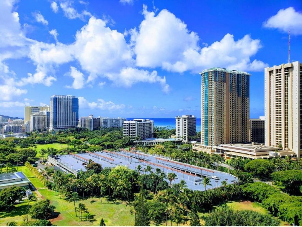 a city skyline with tall buildings and a body of water at Soothing Hawaii Condo - 18F in Honolulu