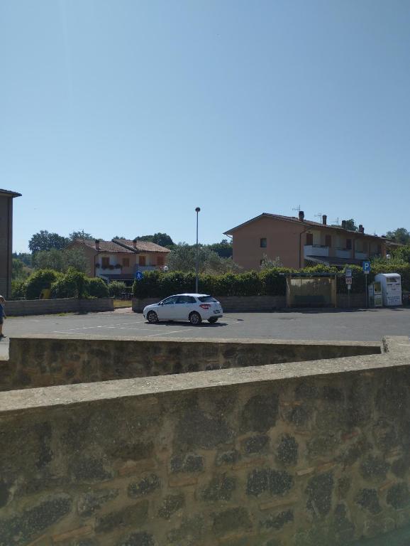 a white car parked in a parking lot at Capretto Gian Piero in San Quirico