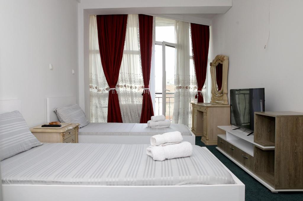 Postel nebo postele na pokoji v ubytování Hotel Xhema