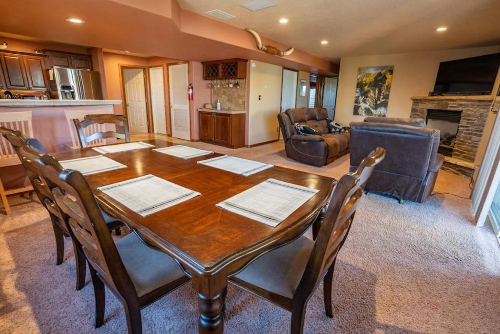 a dining room with a wooden table and chairs at Bear Creek Lodge - Spa - Fire Table - 3min to Trails in Colorado Springs