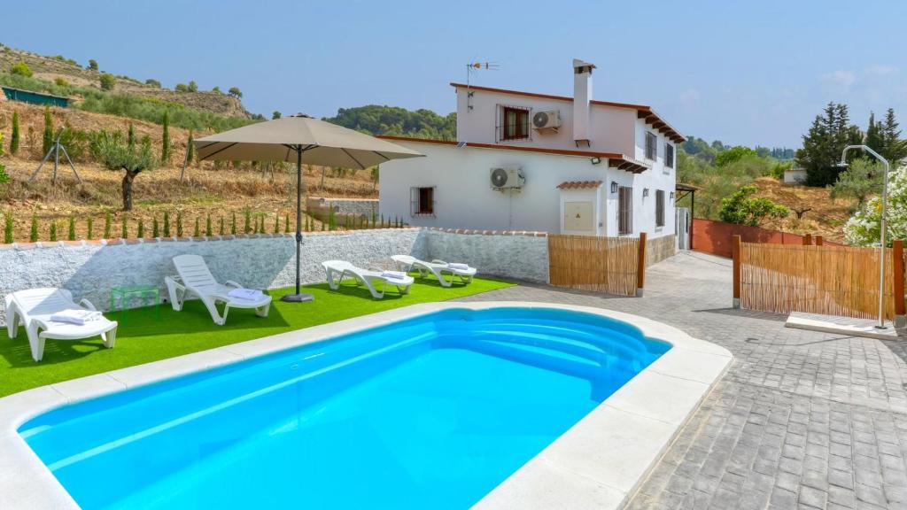 a swimming pool in a yard with a house at La Pasadilla Alozaina by Ruralidays in Alozaina