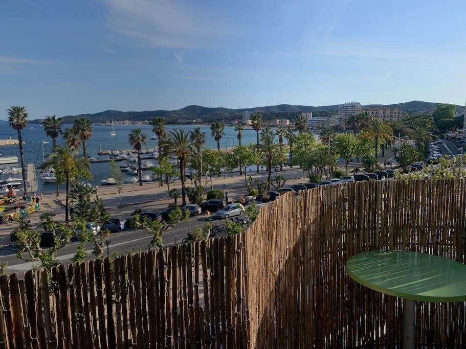 a fence with a view of a city and the water at T3 vue mer in Le Lavandou