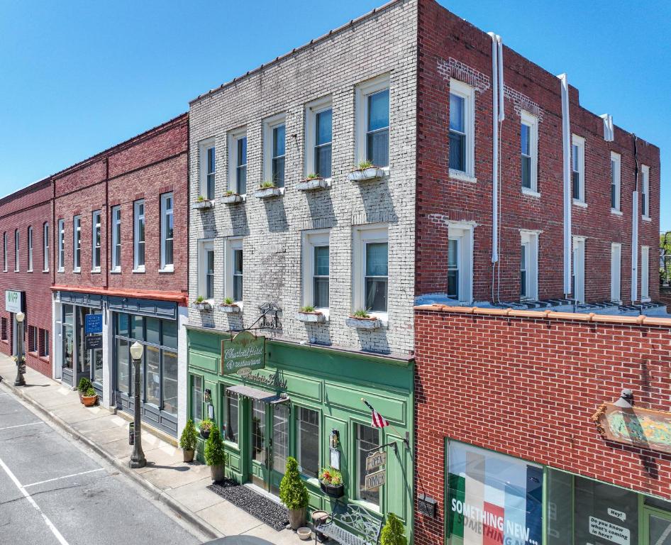 a row of brick buildings on a city street at The Charlotte Hotel & Restaurant in Onancock