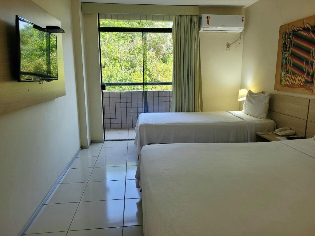 Postel nebo postele na pokoji v ubytování Praiabella Hotel