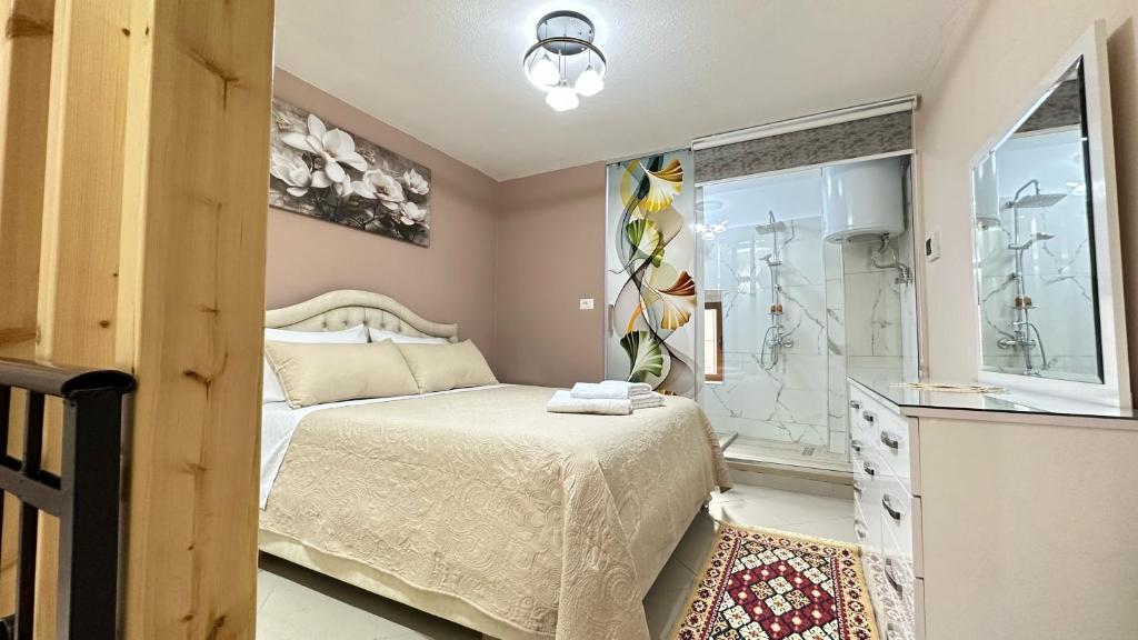 a small bedroom with a bed and a shower at Duplex Mino, Pazari i Vjetër Korçë in Korçë