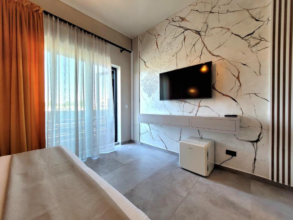 a bedroom with a wall with a tv on it at AMAZE Costinesti in Costinesti