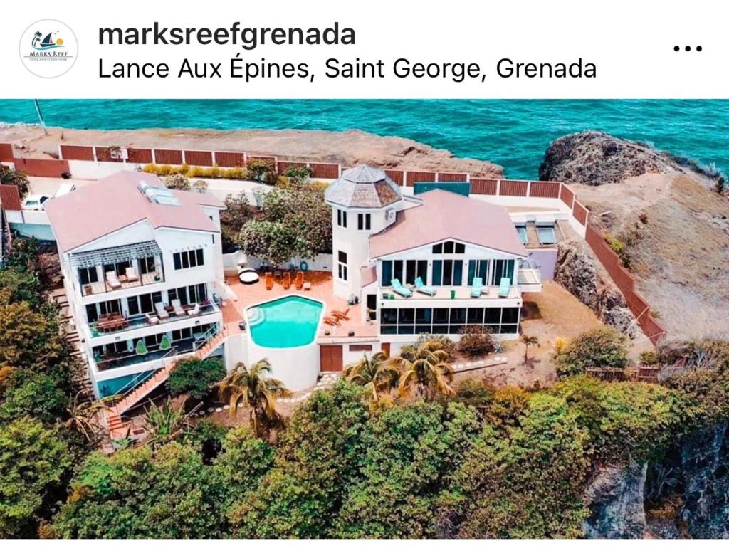 an aerial view of a house on the beach at Marks Reef in Lance aux Épines